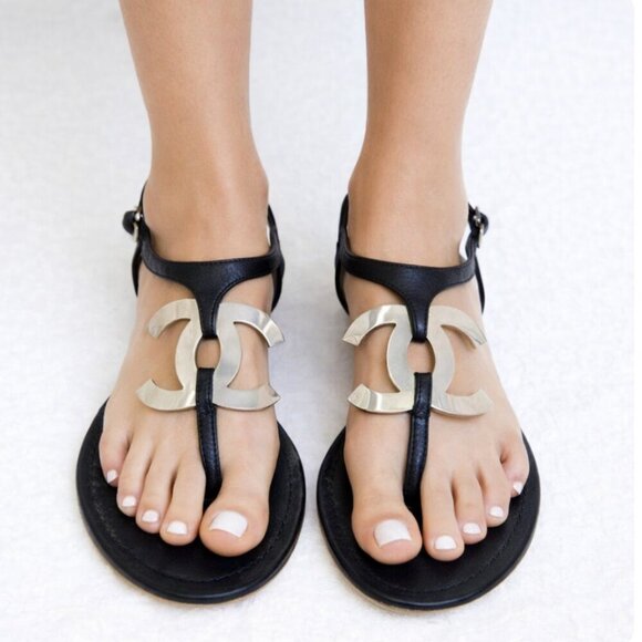 CHANEL Shoes - Chanel Black leather thong sandals size 37 7 big silver metal logo flats